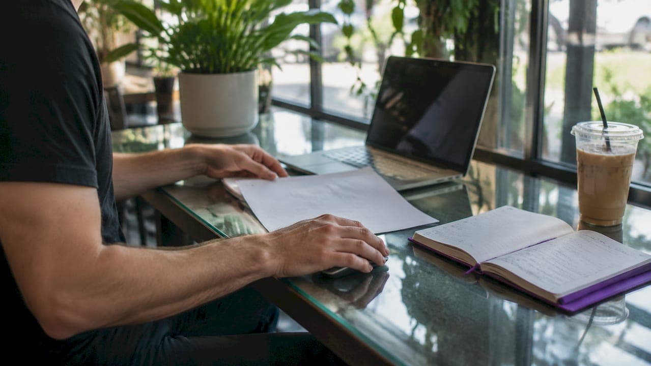 Hands preparing APA document setup at desk
